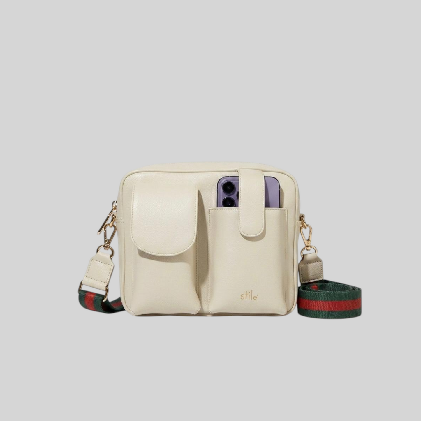 An Ivory leather crossbody phone case with 2 front pockets and a green and red web stripe shoulder strap, shown on a light gray background.