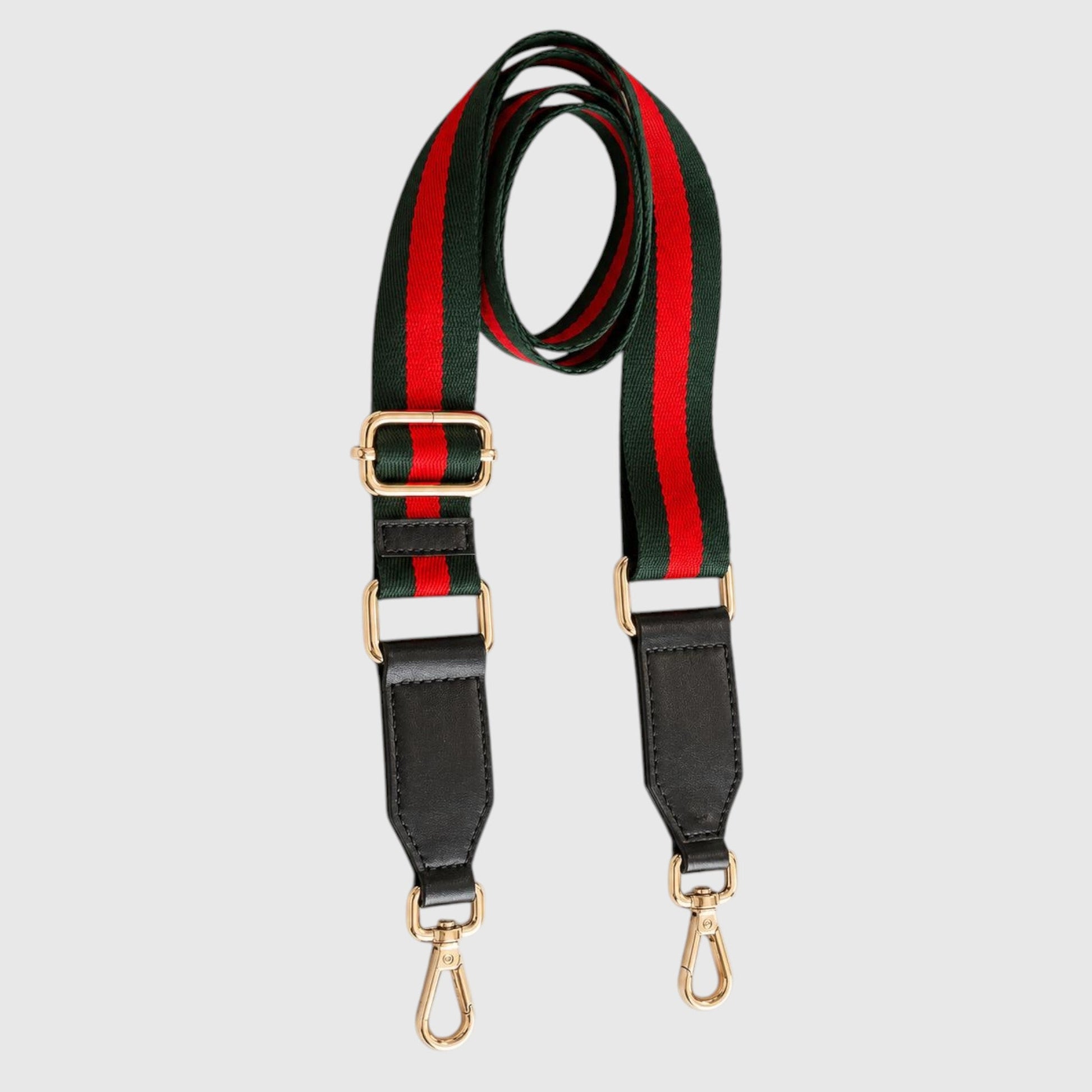A striped shoulder strap featuring the iconic green and red web stripe pattern, black leather ends, and gold-tone hardware, displayed on a light gray background.