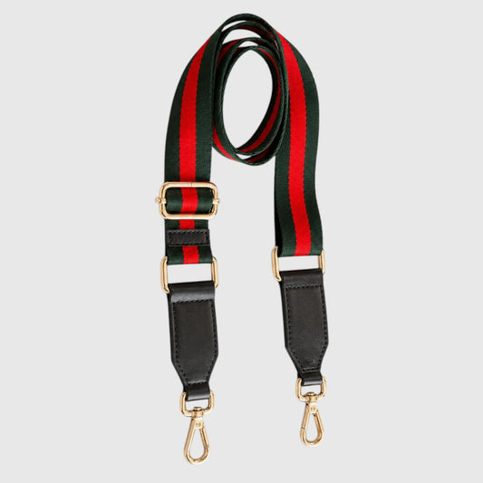 A striped shoulder strap featuring the iconic green and red web stripe pattern, black leather ends, and gold-tone hardware, displayed on a light gray background.
